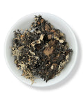 A dish containing dried Lobaria pulmonaria, also known as lungwort lichen, against a white background.