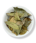 A bowl containing dried soursop leaves.