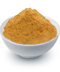 A white bowl filled with finely ground yellow-orange gentian root powder on a white background.