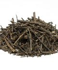 Dried guaraná stems and twig pieces arranged in a loose pile on a white background.